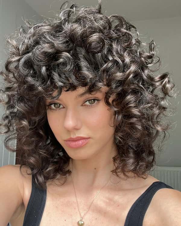 Thick Curly Shag Haircut with Bangs