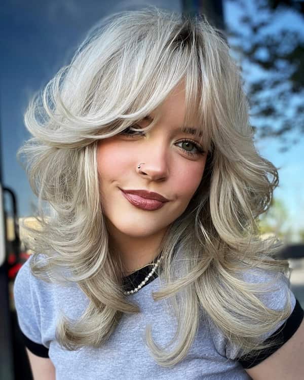 Blonde Shaggy Haircut with Layers and Curtain Bangs