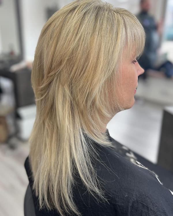 Simple Blonde Layered Haircut with Banga for Older Women
