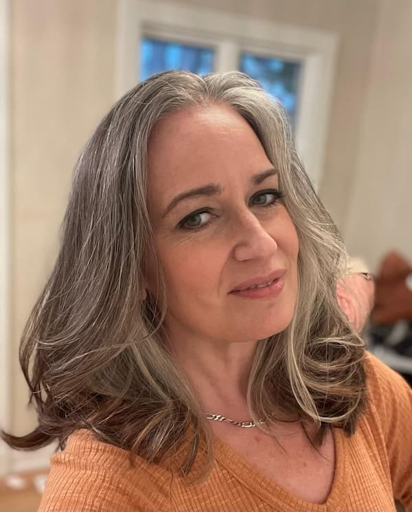 Medium-Length Gray Haircut with Blow-Out Curls