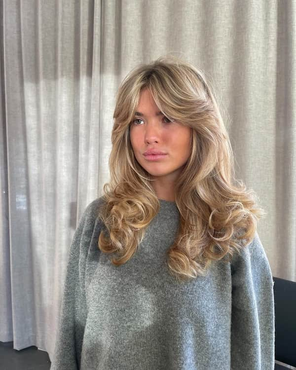 Ash Blonde Voluminous Curly Hair with Curtain Bangs