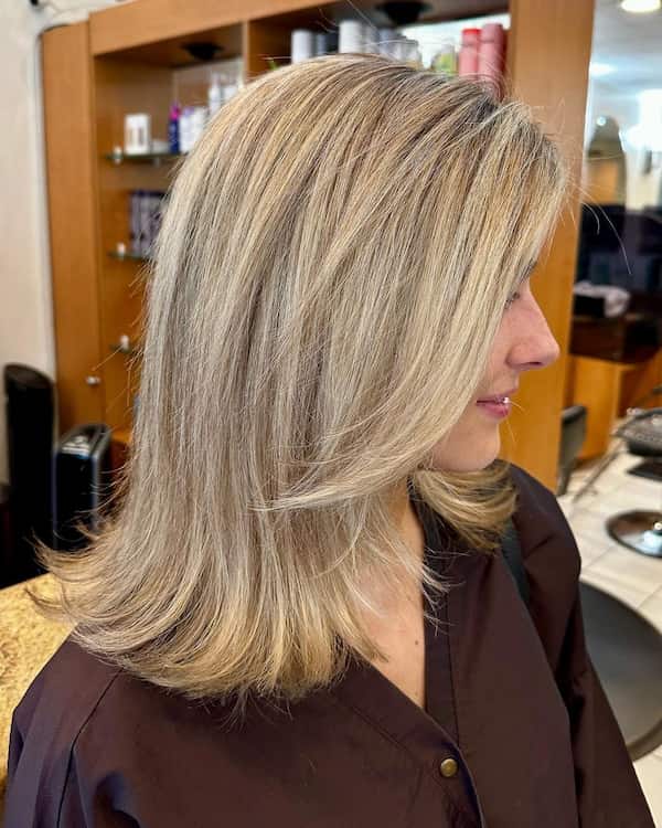 Blonde Haircut with Bangs and Curved Ends