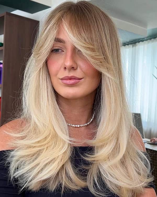 Blonde Layered Haircut with Feathered Curtain Bangs