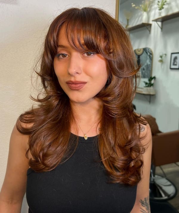 Warm Brown Haircut with Layers and Feathered Bangs