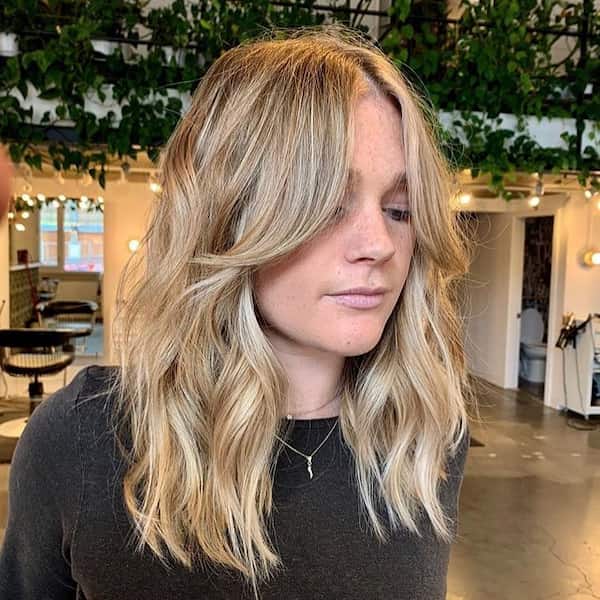 Wavy Haircut with Swoopy Curtain Bangs