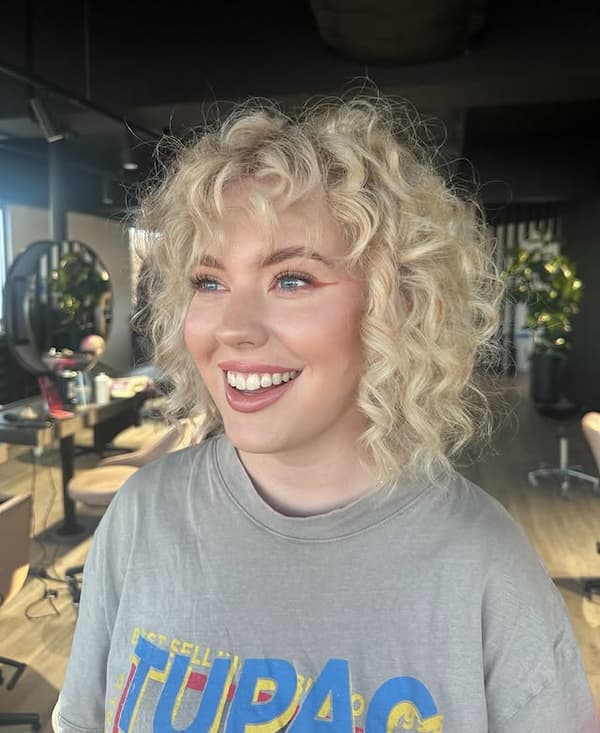 Soft Blonde Curly Bob with Wispy Bangs
