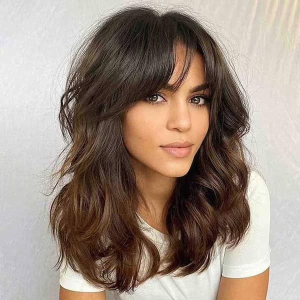 Brown Layered Wavy Haircut with Choppy Bangs