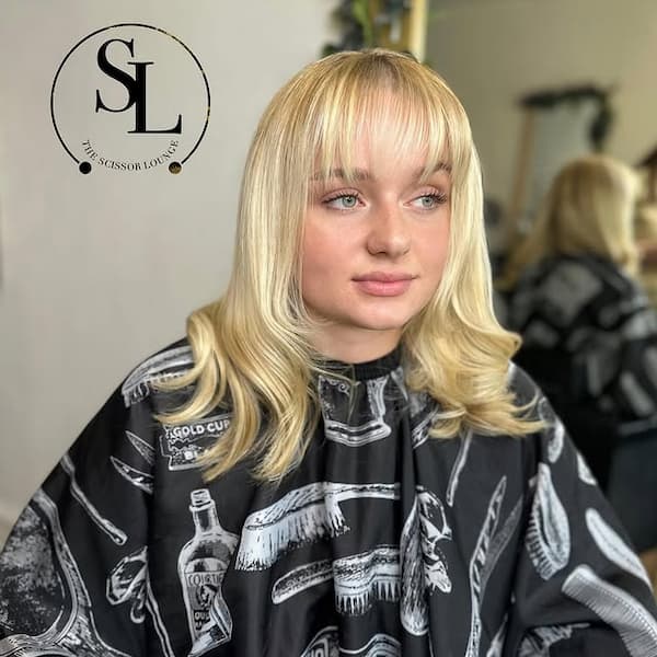 Pure Blonde Mid-Length Haircut with Wispy Bangs 