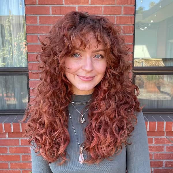 Voluminous Curly Haircut with Bangs 